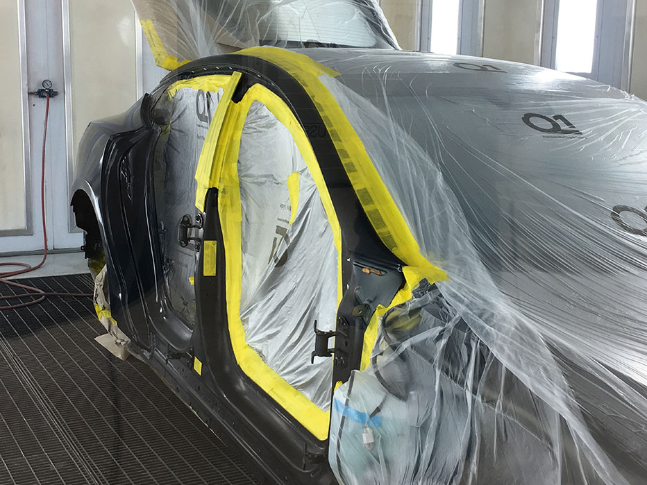 Q1 yellow masking tape on a car in an auto body shop