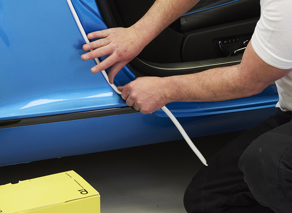 Foam masking tape applied to car door gap